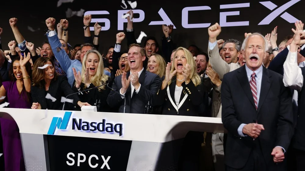 Bret Johnsen, chief financial officer of Space Exploration Technologies Corp. (SpaceX), center, and Gwynne Shotwell, president of Space Exploration Technologies Corp. (SpaceX), center right, during the company's initial public offering (IPO) at the Nasdaq MarketSite in New York
